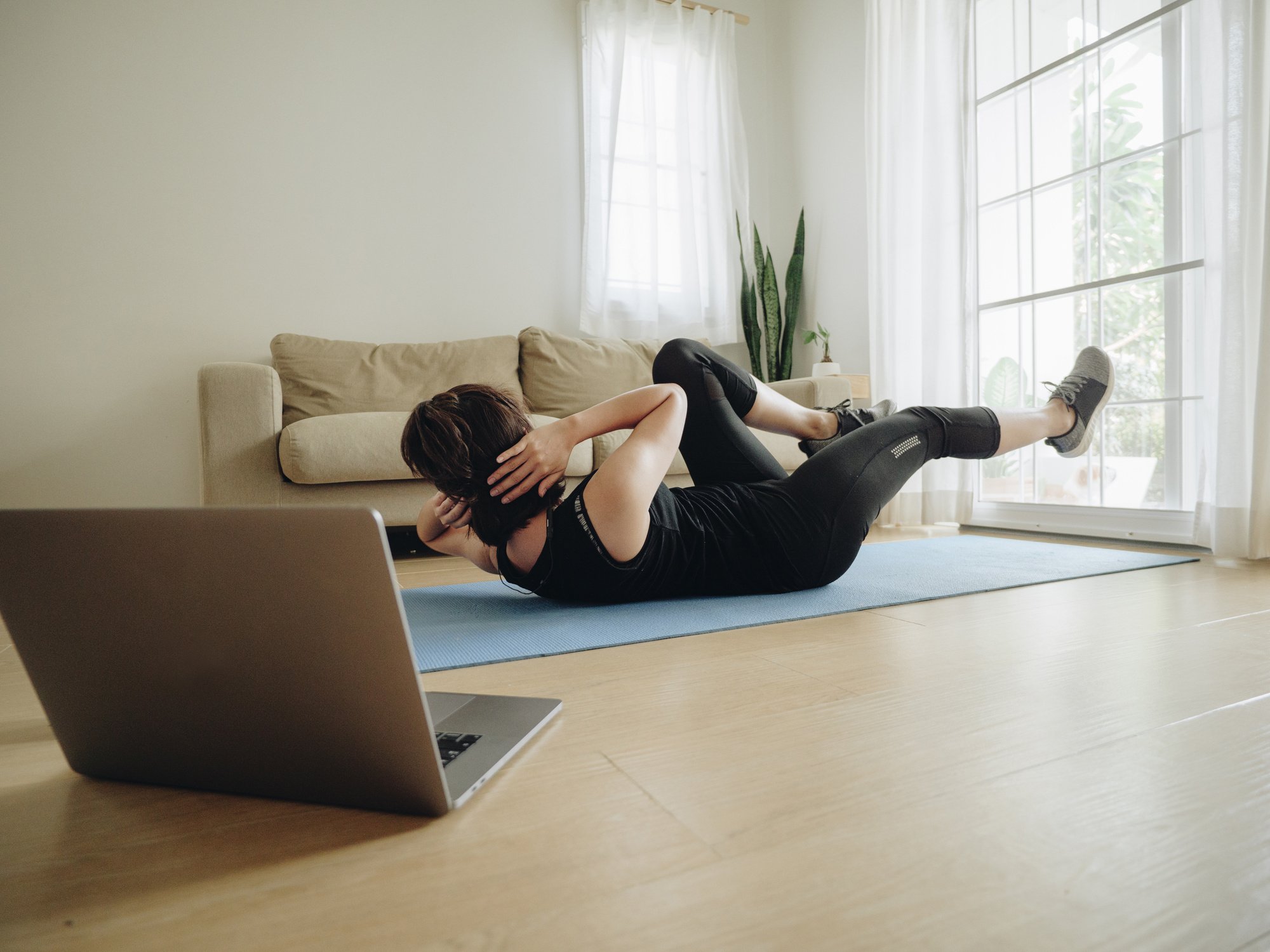 Woman doing home workout in living room at home.